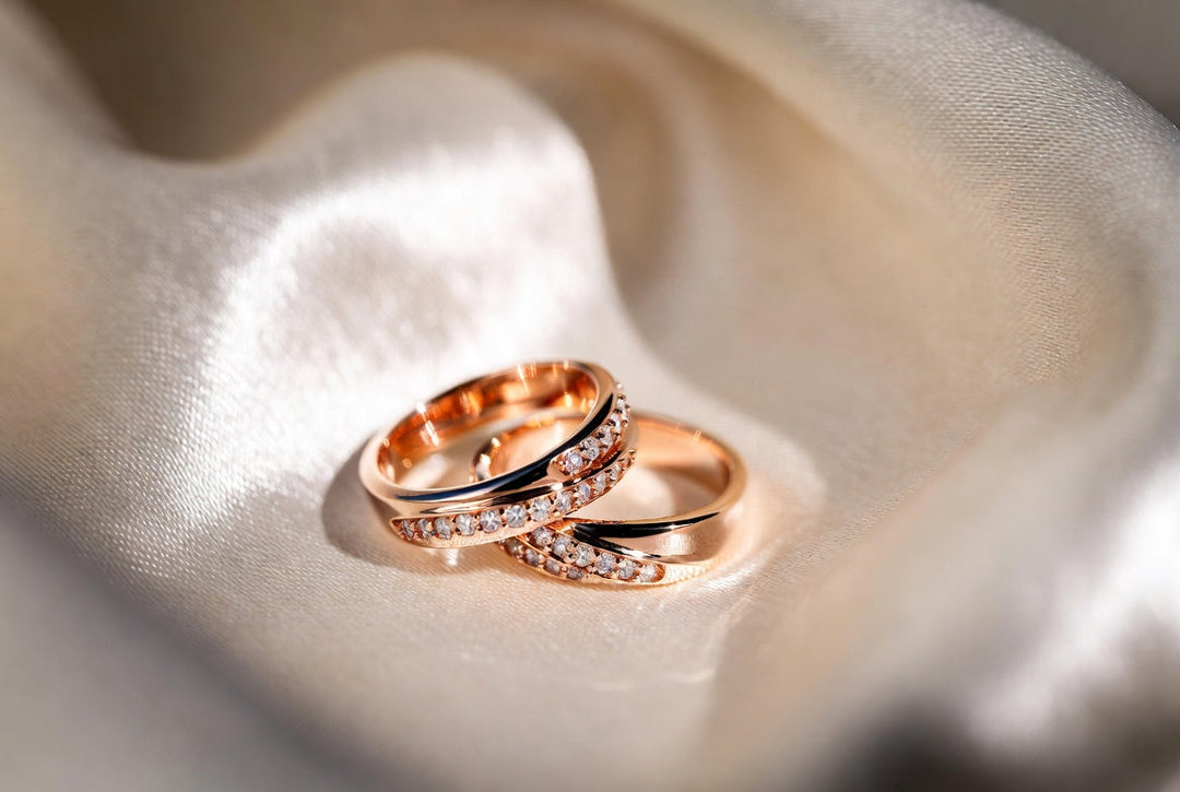 Macro shot of polished rose gold rings on silk showing the signature pink glow.