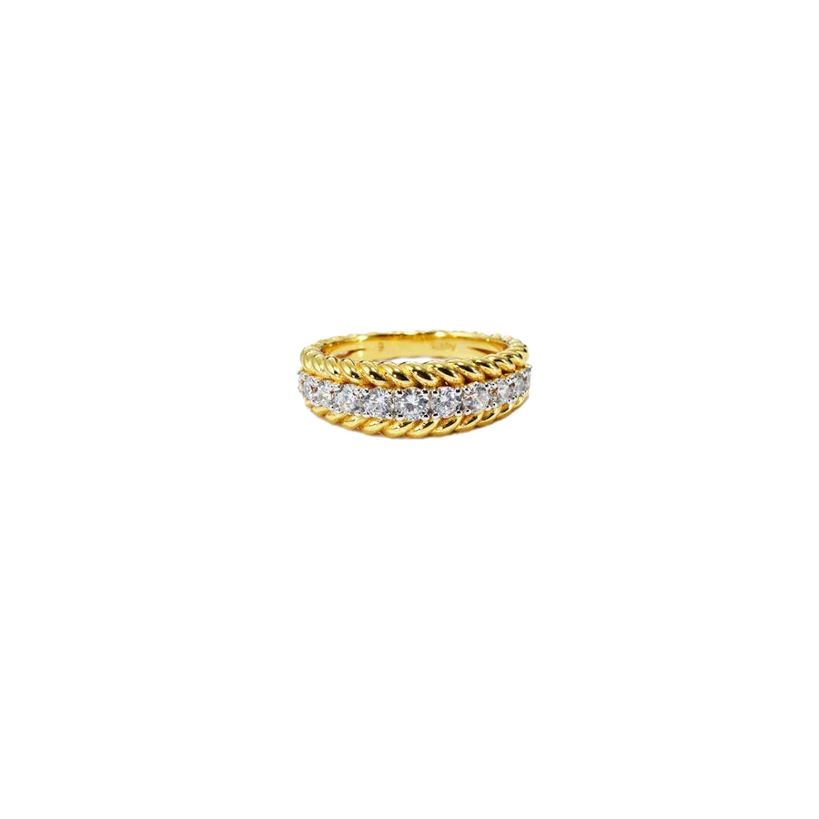 Gold ring with diamond accents on a white background