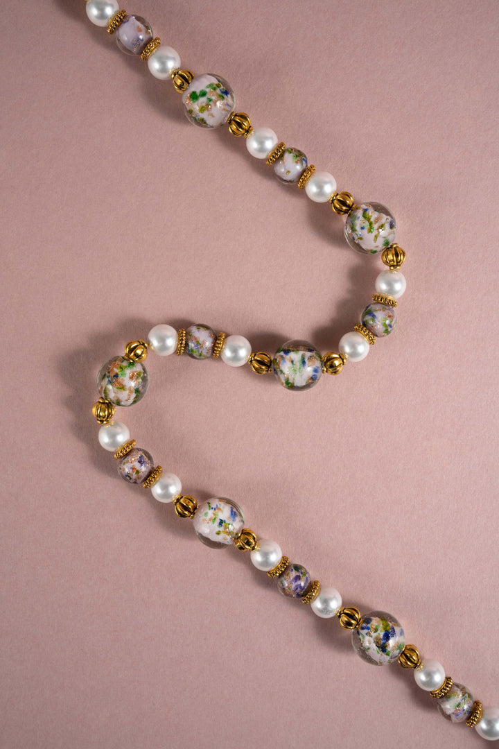 Artisanal Oriental style Liuli glass flower bead necklace with freshwater pearls and retro gold details, vintage Eastern aesthetic statement jewelry.